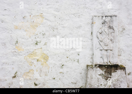 Highlander effigy on an outside wall of Old Ferry House, now a remote self-catering house. Stock Photo