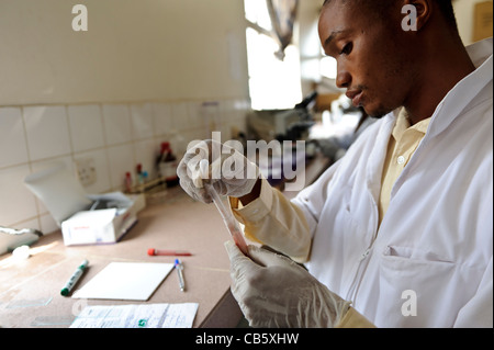 A laboratory technician in a hospital testing blood samples for Malaria, Freetown, Sierra Leone. Stock Photo