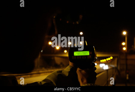 Police carryout a speed check on a motorway at night Stock Photo