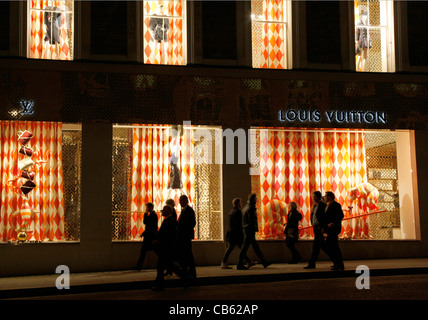 Shoppers with Louis Vuitton bags in Oxford Street London, pass bus with  advert for fashion outlet boohoo Stock Photo - Alamy