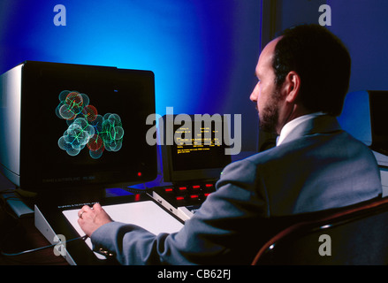 Scientist studying a molecular model illustration on computer equipment in a corporate research & development laboratory Stock Photo