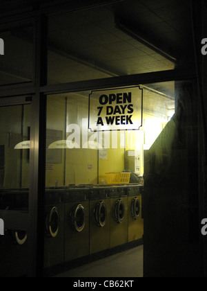 Looking through a launderette window at night Stock Photo
