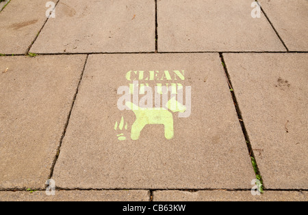 A stencil message on a pavement in Yorkshire UK suggesting owners should clean up after their dogs have defecated Stock Photo