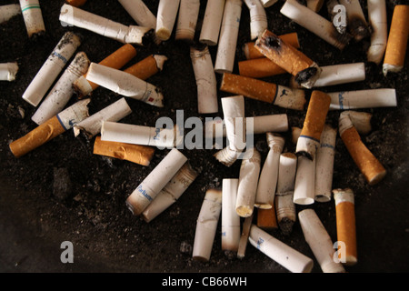 Cigarette butts in ashtray. Stock Photo