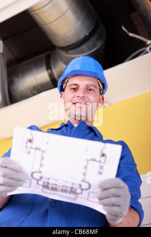 Engineer with a heating plan Stock Photo