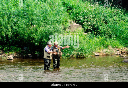 Fly fishing angling anglers on the River Usk at Crickhowell, Powys, Wales, UK Stock Photo