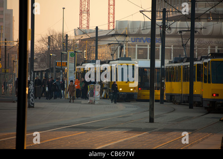 Berlin, Germany, March 03, 2011: Alexanderplatz square, yellow electric tram stop - lot of people people coming in and out of car in the morning rush hour Stock Photo