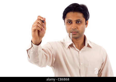 Indian business man writing on a clear screen, add your own text or drawing. Stock Photo