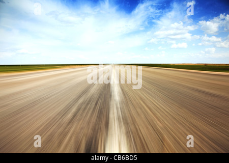 Speed concept. Empty countryside old road stretches in perspective. Stock Photo