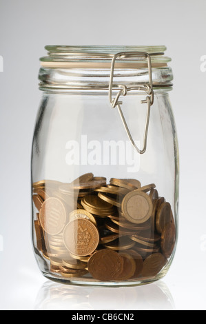 different coins values in a glass jar Stock Photo
