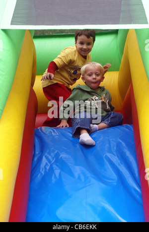 Hesitation before taking turn going down inflatable slide. Stock Photo