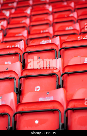 Red seats in the Lincolnshire Echo Stand, formerly the St Andrew's Stand, at Lincoln City Football Club's Sincil Bank Stadium Stock Photo