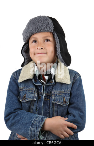Young smiling boy in warm woolen hat and denim jacket on white background Stock Photo
