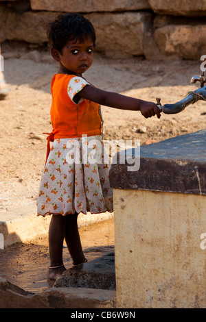 hampi ruins water girl tap thirsty dress dirty Stock Photo