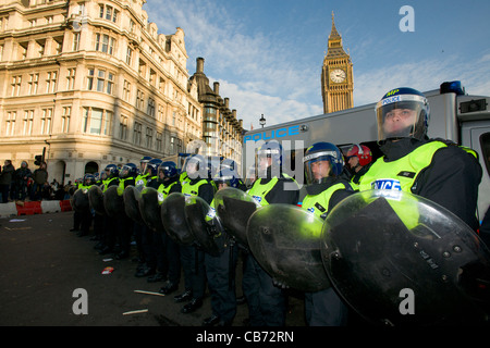 Police line in full riot gear guarding the Houses of Parliament, Day X3 Student Demonstration, London, England Stock Photo