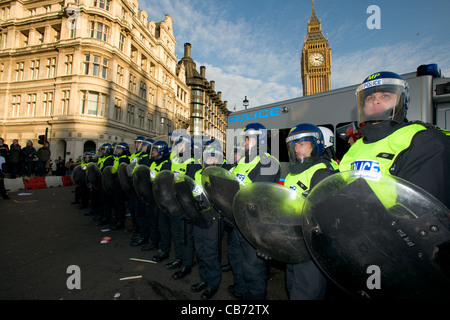 Police line in full riot gear guarding the Houses of Parliament, Day X3 Student Demonstration, London, England Stock Photo