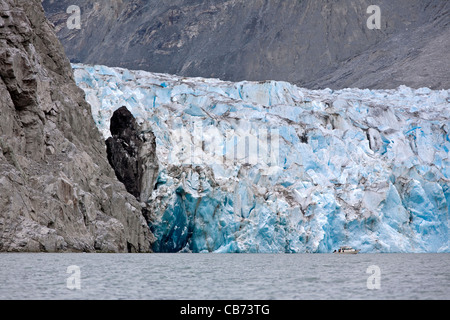 Small boat in front of McBride glacier. Muir Inlet. Glacier Bay National Park. Alaska. USA Stock Photo