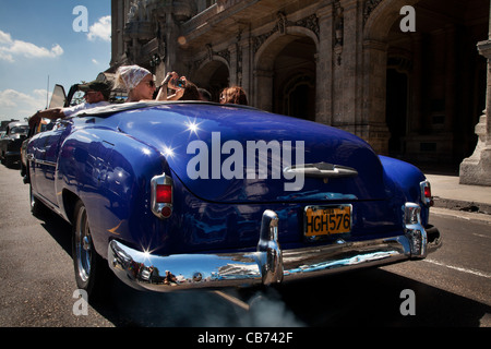 Tourists in a vintage car, Havana (La Habana), Cuba Stock Photo