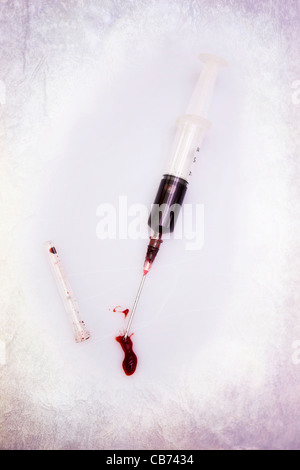 a syringe filled with blood Stock Photo