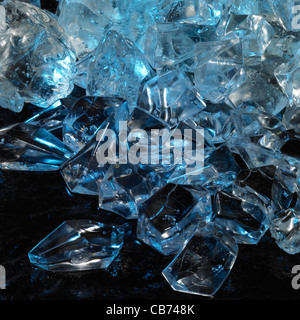 studio photography of blue illuminated ice cubes in dark back Stock Photo