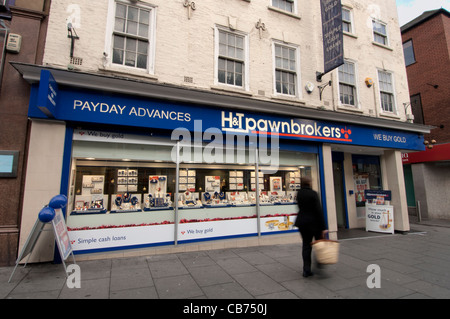 Pawnbrokers' frontage, with woman hurrying paste - motion blur. Stock Photo
