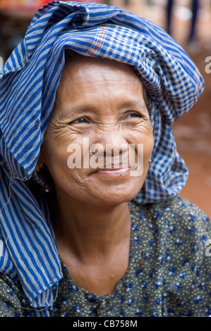 Portrait of smiling Cambodian woman in blue krama at village festival, Cambodian New Year (Chaul Chnam Thmey), Bakong Village, Siem Reap, Cambodia Stock Photo