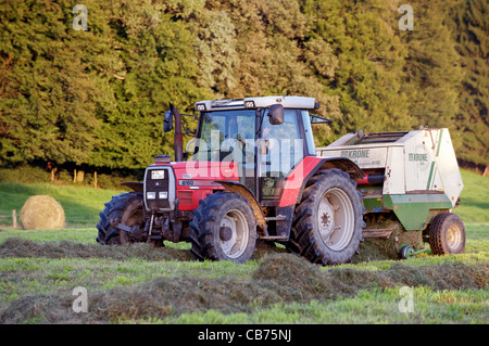 Farmer bailing hay Stock Photo