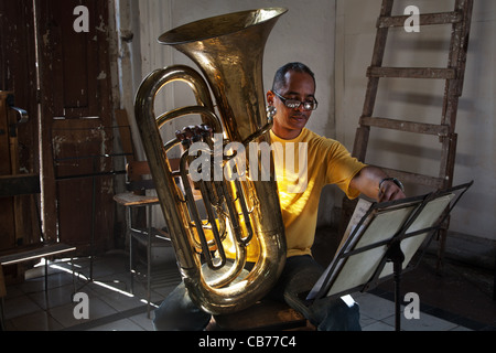 A tuba player taking notes in the Asociacion Rosalia de Castro, Havana (La Habana), Cuba Stock Photo