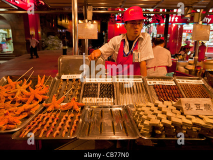 serving exotic food at the Wangfujing night market, Beijing,PRC Peoples Republic of China, Asia Stock Photo