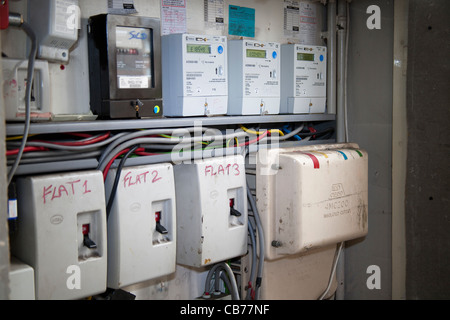 Electrical Supply and Distribution units showing meters and main incomers with meters displaying debt amounts Stock Photo