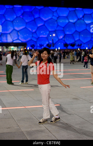 Beijing, China September 13, 2008: Chinese woman enjoying the vast plazas outside the National Swim Center (Water Cube) Stock Photo