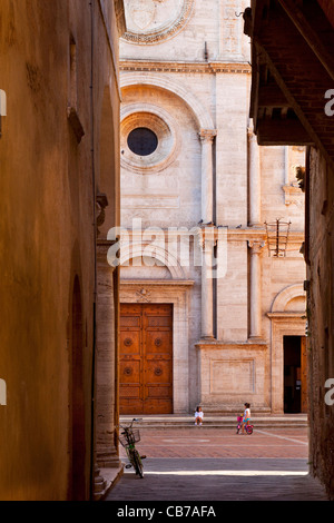 Two young girls play below the Cathedral in Piazza Pio, Pienza Tuscany Italy Stock Photo