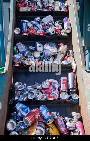 Aluminum cans on conveyer belt ready to be crushed. Recycling Center, Los Angeles, California, USA Stock Photo