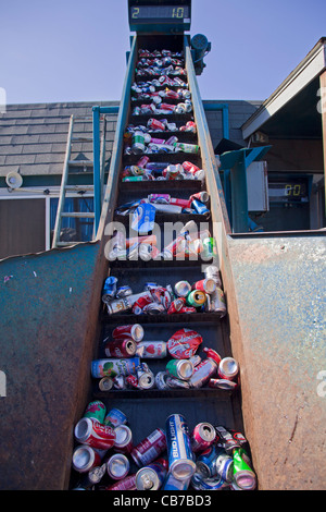 Aluminum cans on conveyer belt ready to be crushed. Recycling Center, Los Angeles, California, USA Stock Photo