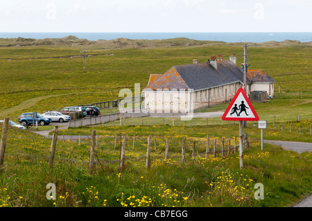 School road sign in the small settlement of Eoligarry in the north of the Isle of Barra, Outer Hebrides. Stock Photo