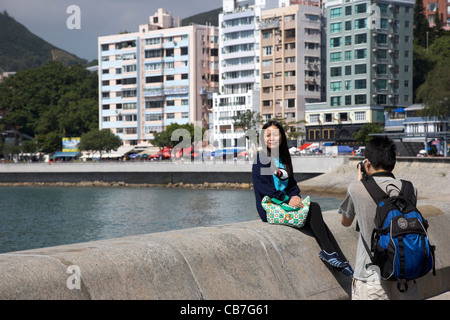 young chinese couple taking photos on stanley waterfront hong kong, hksar, china Stock Photo