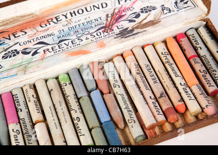 A close up photograph of a box of colorful used chalk pastels