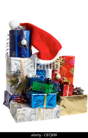 A big mountain with christmas gifts and a red santa hat isolated on white background Stock Photo