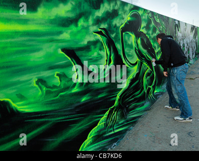 Urban artist Dan Kitchener painting a legal Graffiti wall. Stock Photo