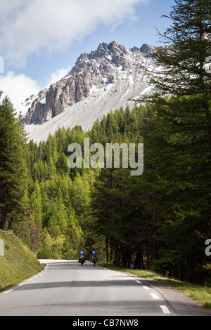 Two cyclists ascending the Col d'Lzoard, Hautes-Alpes, France Stock Photo