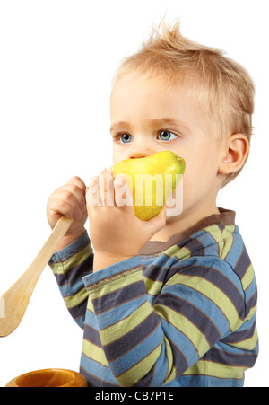 Studio portrait of one year old baby boy eating a ripe pear on white. Stock Photo