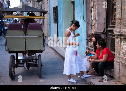 A young girl, freshly reborn and baptized in Santeria, A newborn has to wear white for a whole year, Havana (La Habana), Cuba Stock Photo