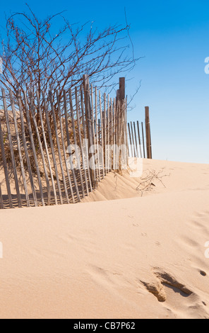 Cape Cod beach fence and sand dunes at beach entrance in Chatham, Cape Cod Stock Photo