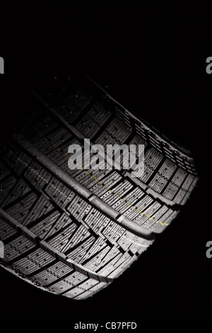 Part of unused car tyre. Vertical composition. Stock Photo