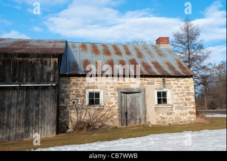 Old stone house with corrugated tin roof near St-Eustache, province of Quebec, Canada. Stock Photo
