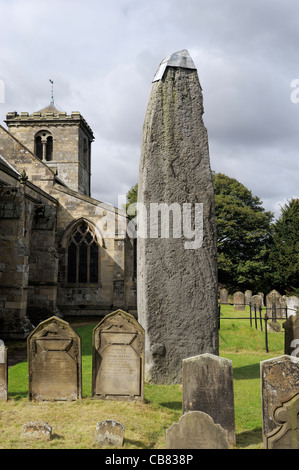 Rudston monolith, late Neolithic 26 ft. standing stone beside Rudtson Parish Church of All Saints, East Yorkshire, England, UK Stock Photo