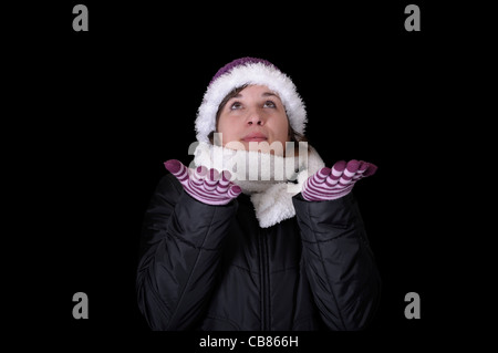 snowing on young woman in winterclothes Stock Photo