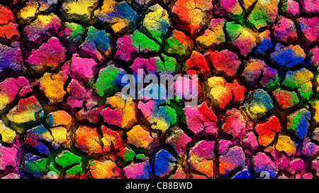 Dried cracked earth covered in colourful powder pattern. India Stock Photo