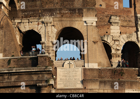 Tourists looking out of the Colosseum in Rome Stock Photo