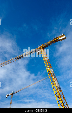 Construction cranes against a blue sky Stock Photo
